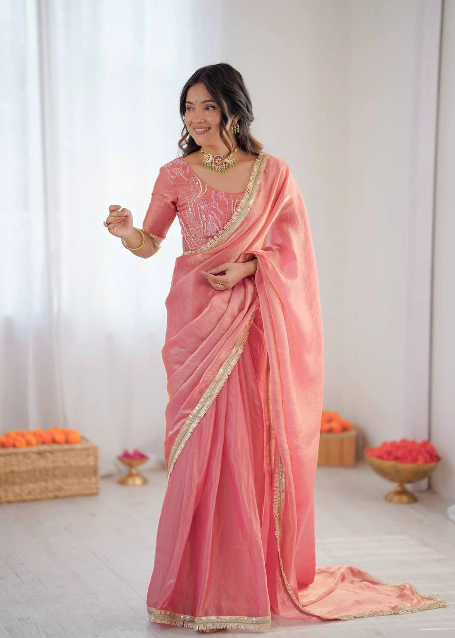 Woman wearing a pink saree with a white background