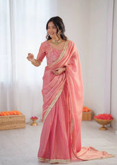 Woman wearing a pink saree with a white background