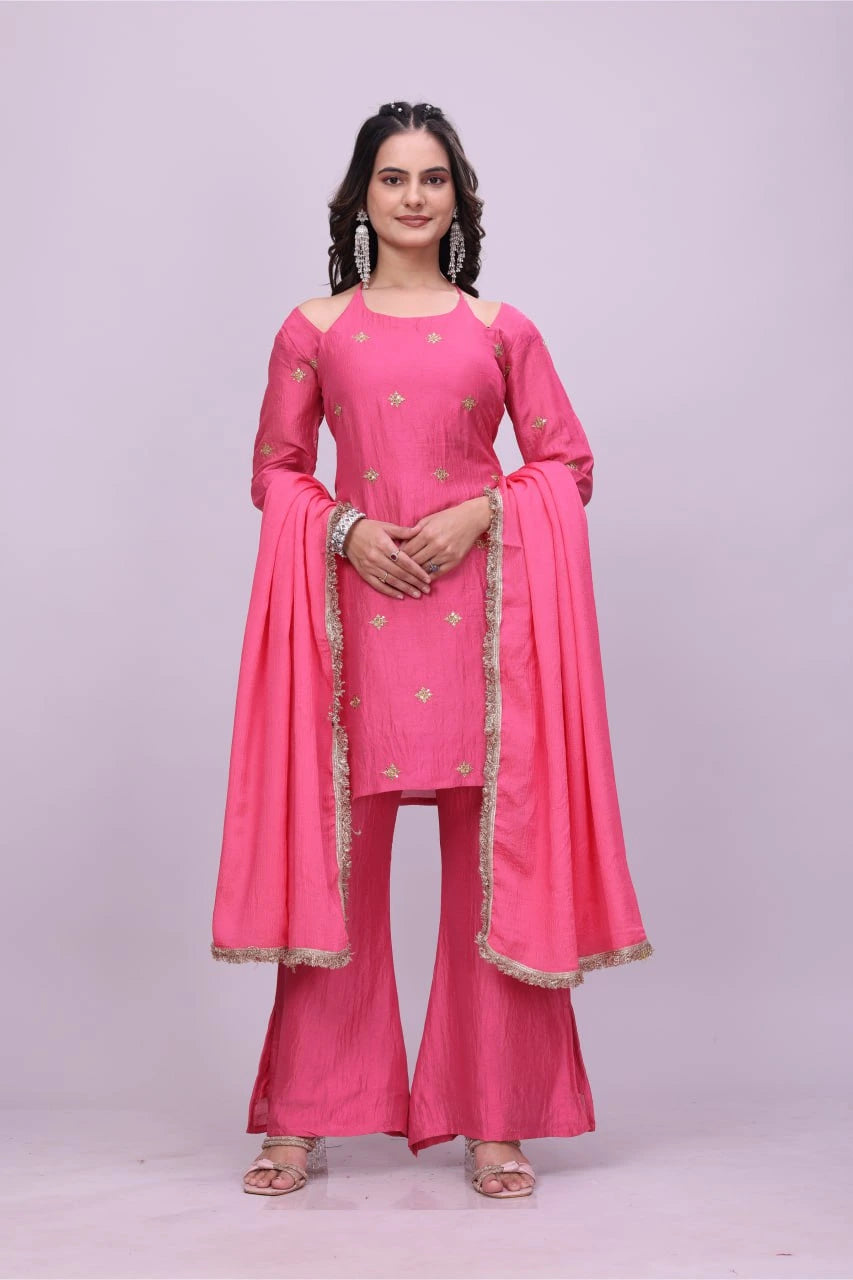 Woman wearing a pink traditional outfit with a matching dupatta on a light purple background
