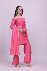 Woman wearing a pink traditional outfit with a matching dupatta on a light gray background