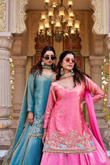 She accessorizes with large statement earrings and round pink sunglasses.
