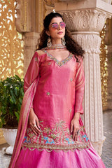 The flowing dupatta adds movement and elegance to the portrait.
