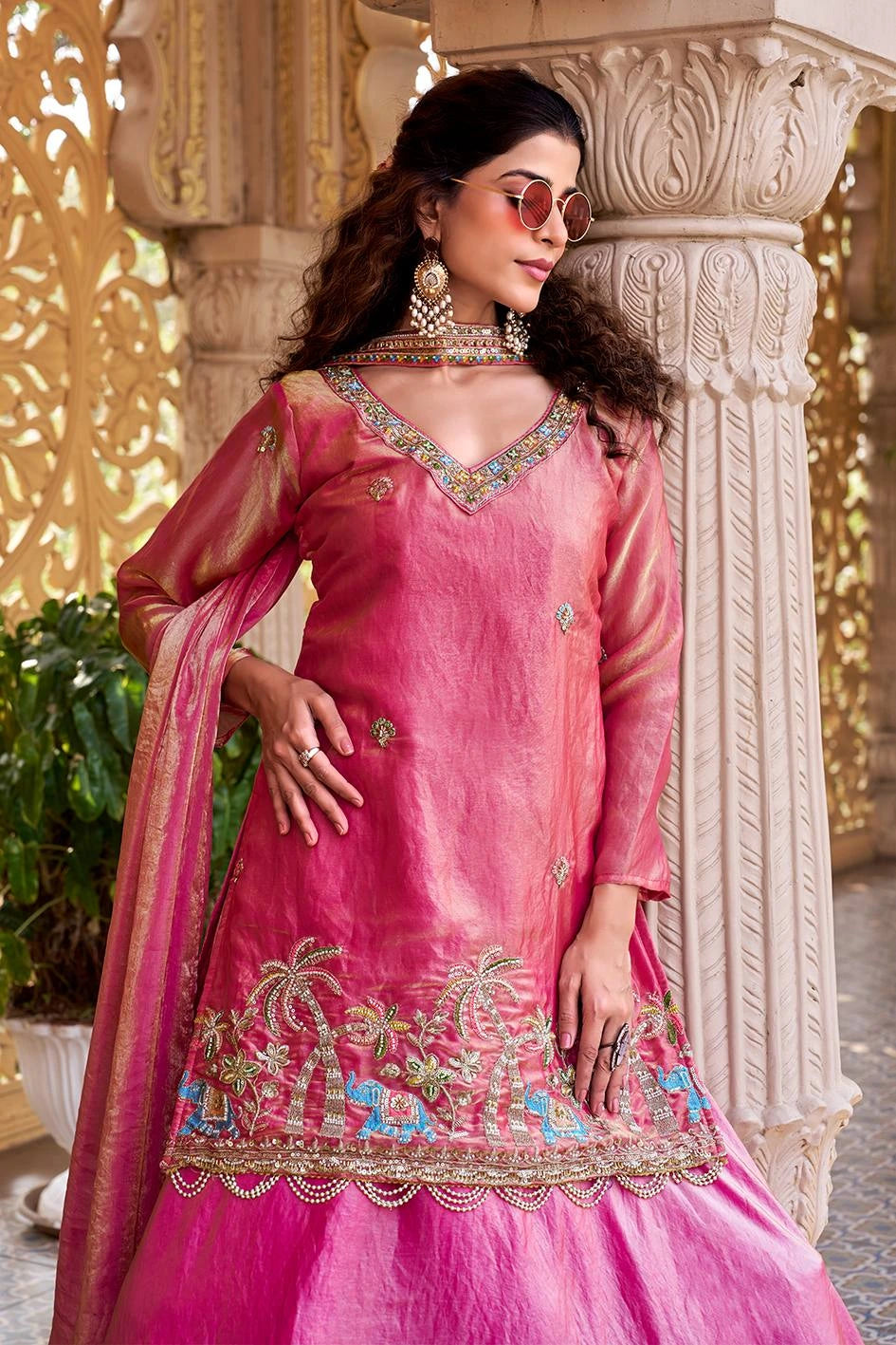 The vibrant pink tones contrast beautifully with the cream and gold architecture.
