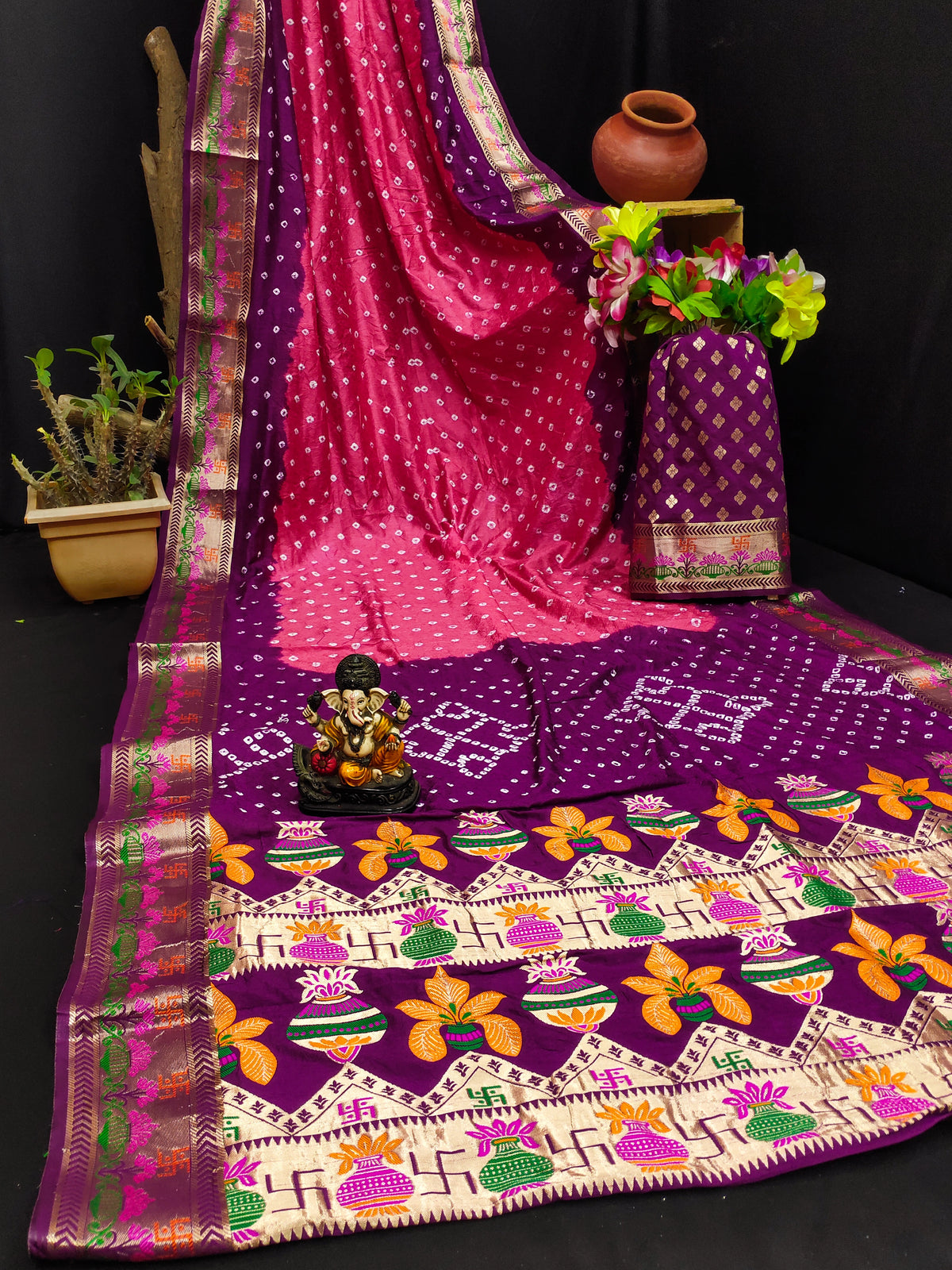 Colorful saree with intricate patterns on a dark background