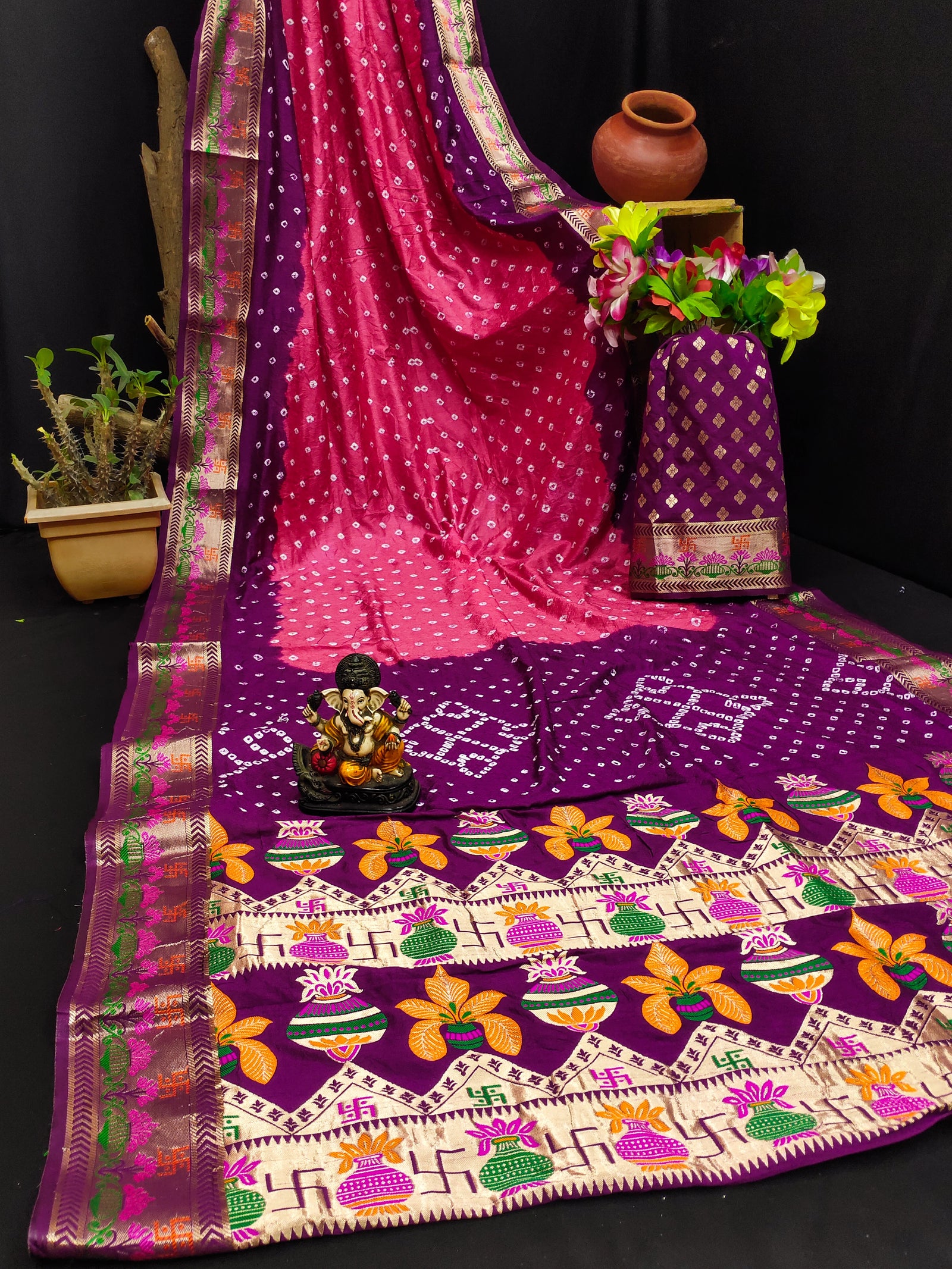 Colorful saree with intricate patterns on a dark background
