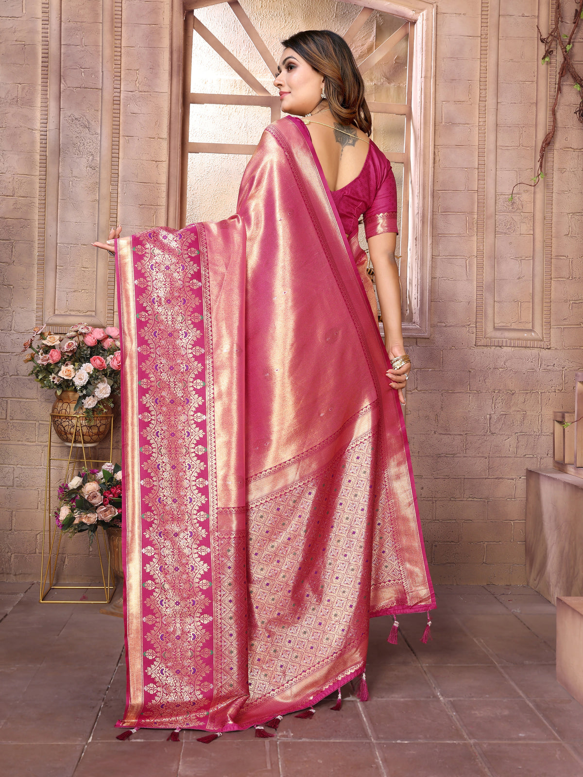 Elevate your ethnic wardrobe with this exquisite Tulip Pink Banarasi Tissue Silk saree, a timeless piece that celebrates heritage craftsmanship. Woven with intricate zari detailing, this saree showcases the signature elegance of pure Banarasi silk in a delicate tissue weave that drapes beautifully.