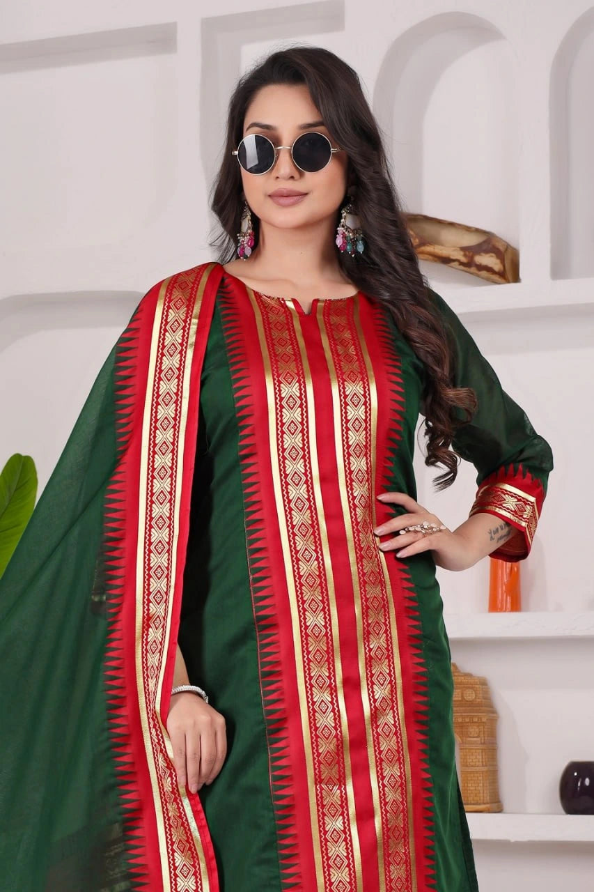 Woman wearing a green and red traditional outfit with a white background