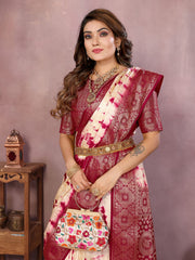 Woman wearing a red and white saree with a floral handbag against a plain background