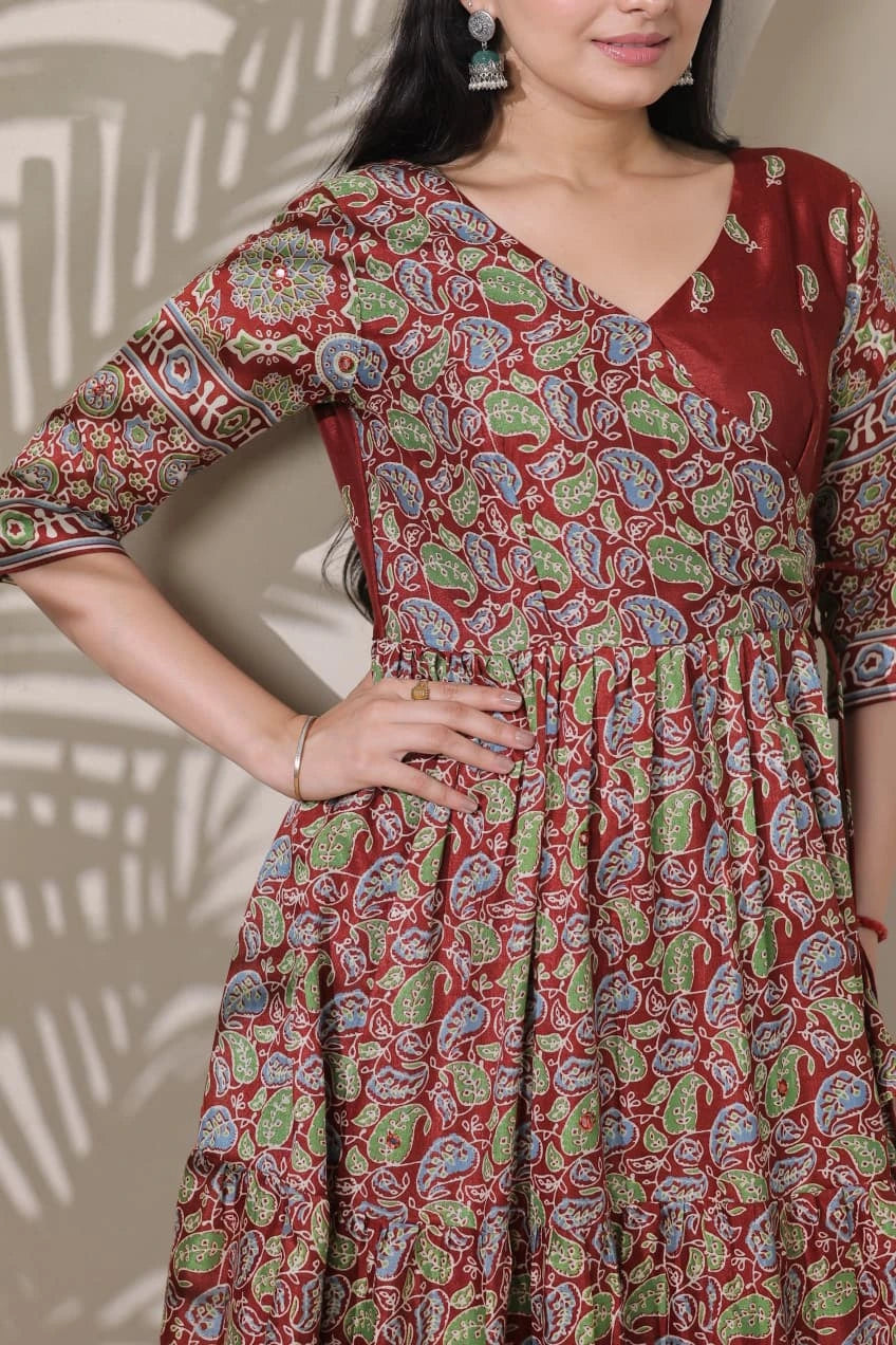 Woman wearing a red patterned dress with a neutral background