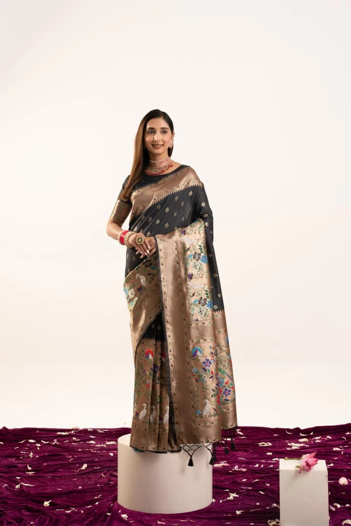 Woman wearing a saree with a floral pattern on a white background