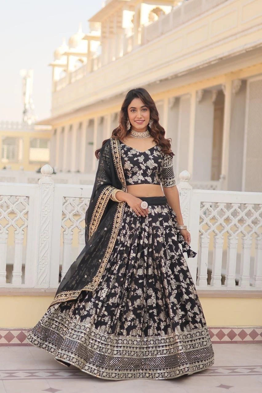 Woman in a black and white patterned traditional outfit standing on a balcony.