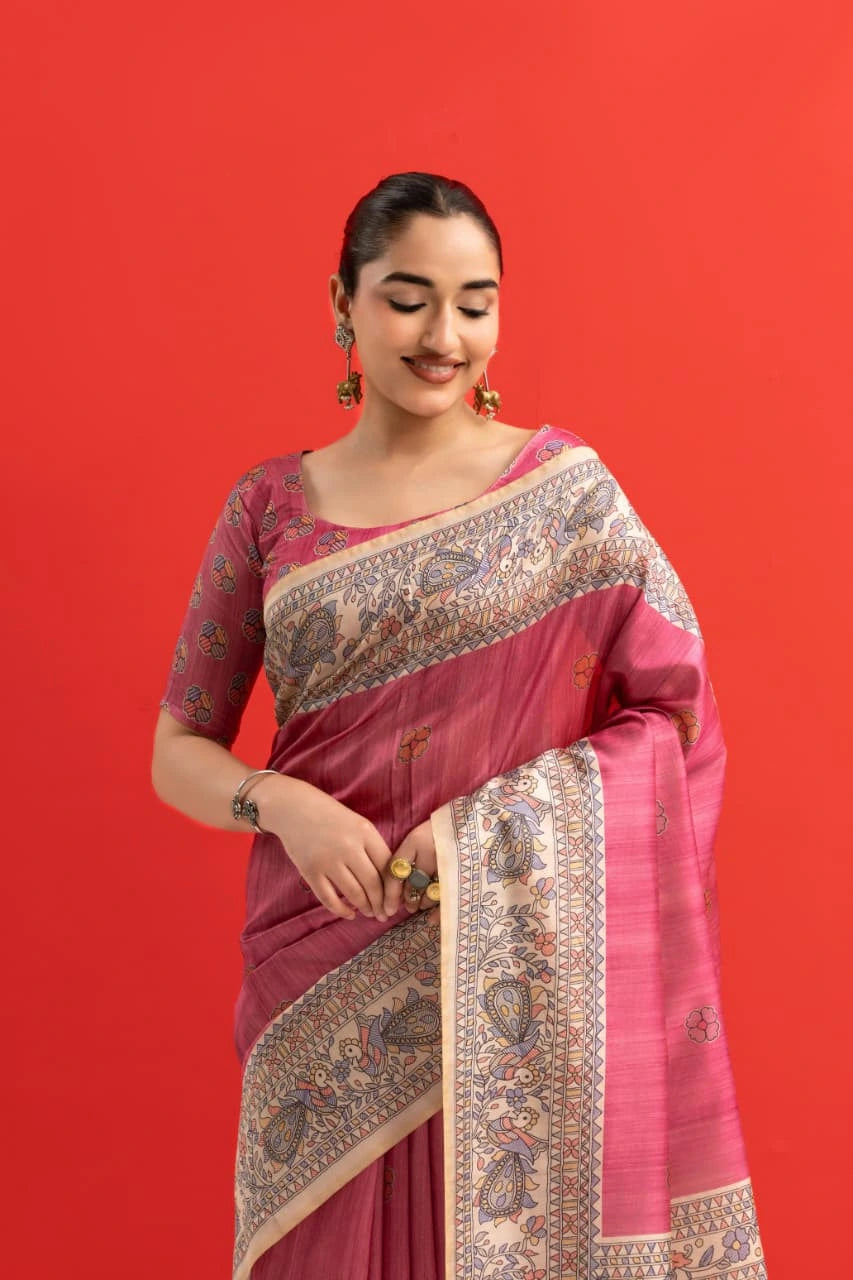 Woman wearing a pink saree with a red background