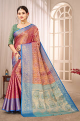 Woman wearing a colorful saree in a well-lit room with curtains and a window.