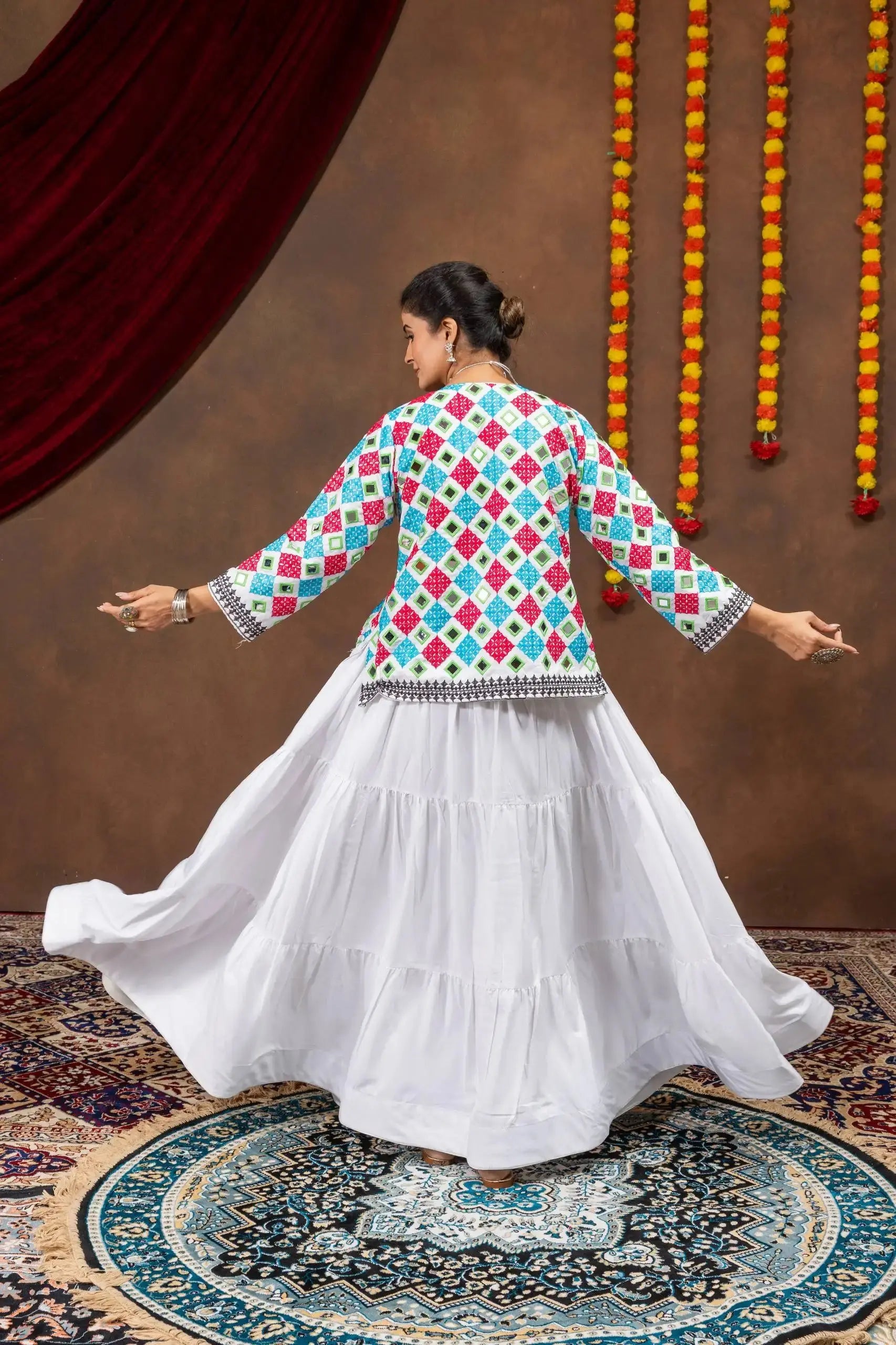 Back twirling view of white 6-meter tiered pure rayon lehenga with multicolor bandhej jacket