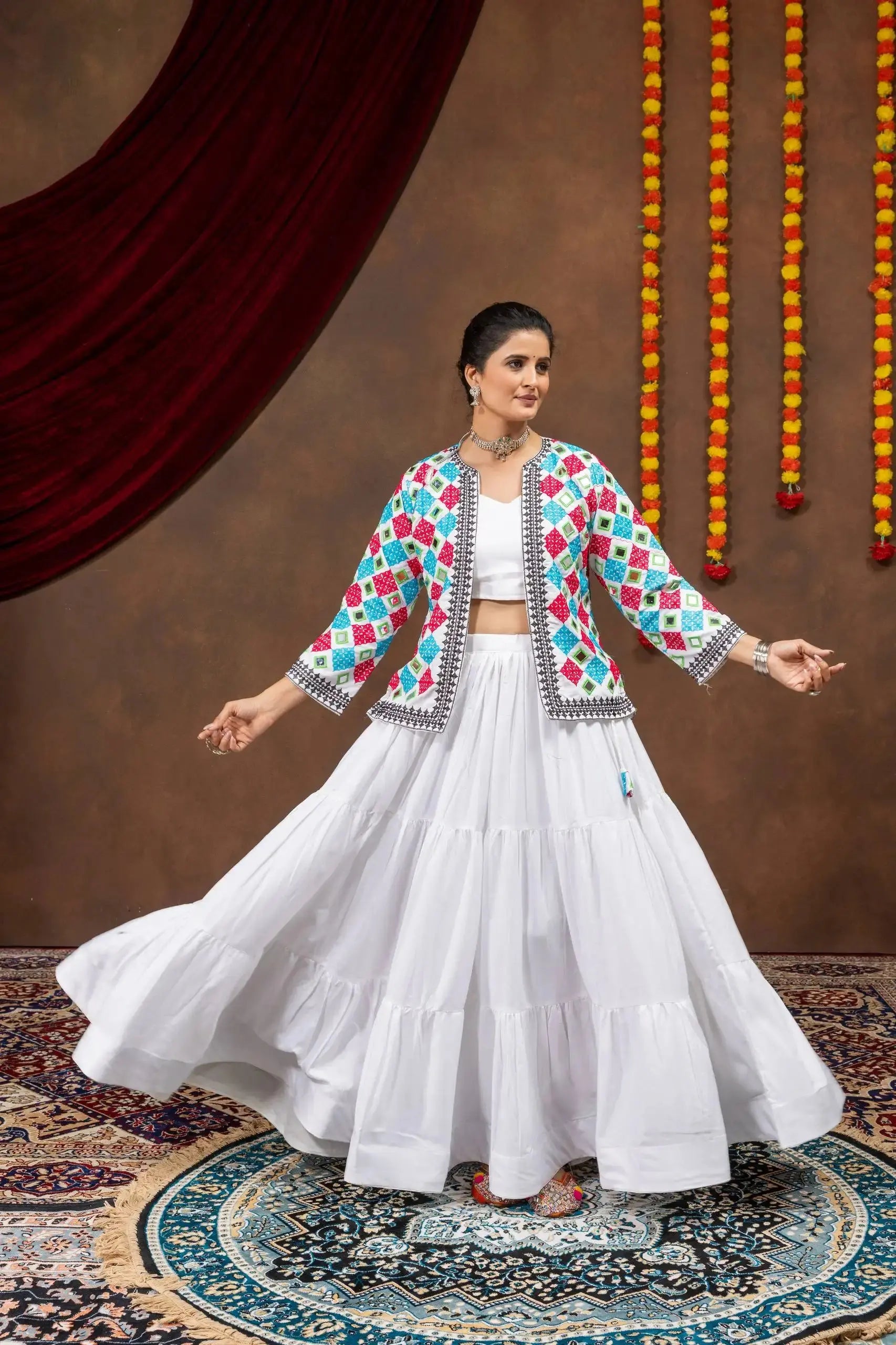 Side twirling view of white 6-meter flair tiered lehenga with bandhej jacket