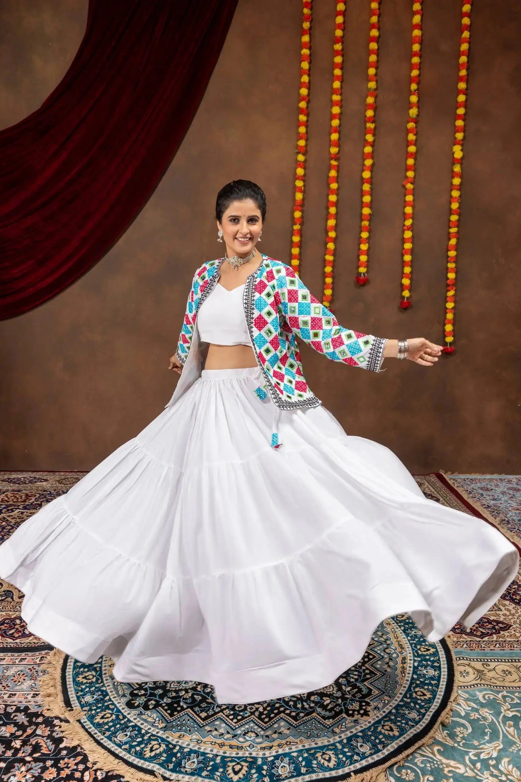 White embroidered mirror work lehenga with bandhej jacket, twirling front view