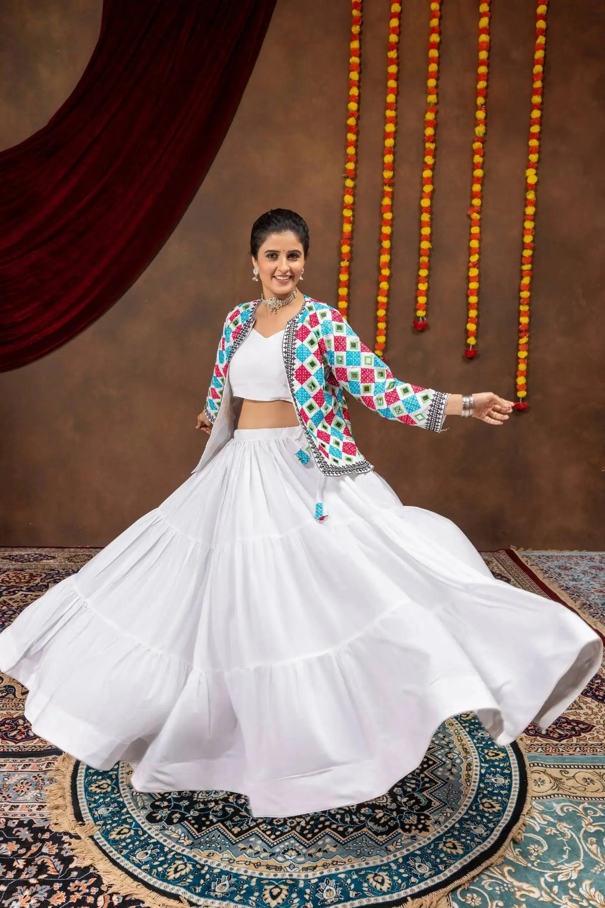 White embroidered mirror work lehenga with bandhej jacket, twirling front view