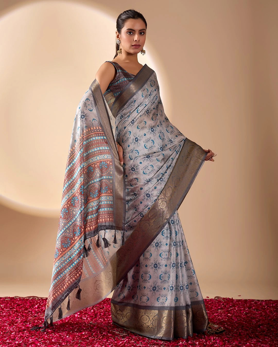 Woman wearing a patterned saree on a beige background