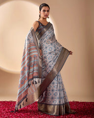 Woman wearing a patterned saree on a beige background