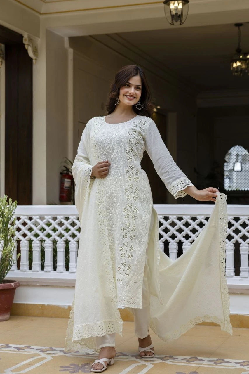 Woman in a white traditional outfit standing on a balcony