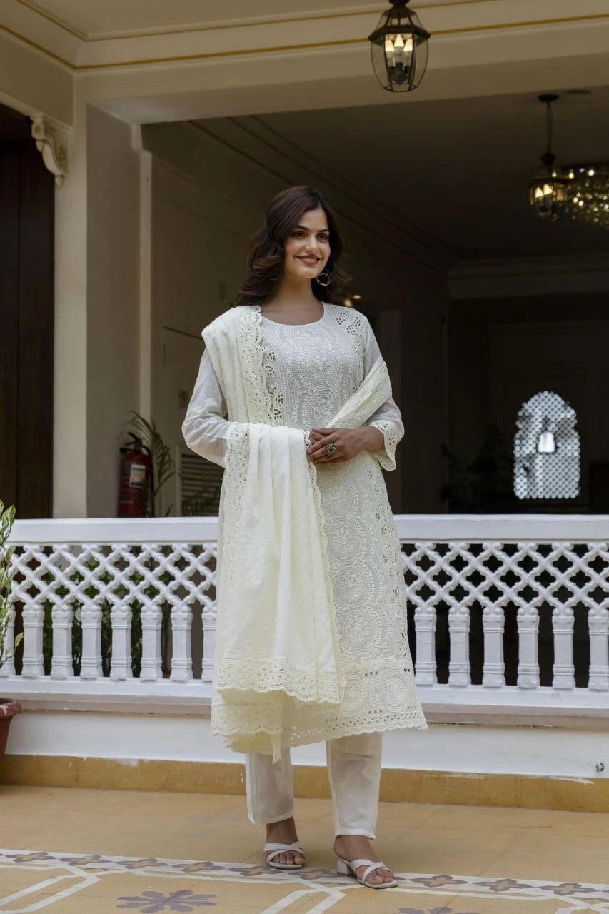 Woman in a white traditional outfit standing on a balcony
