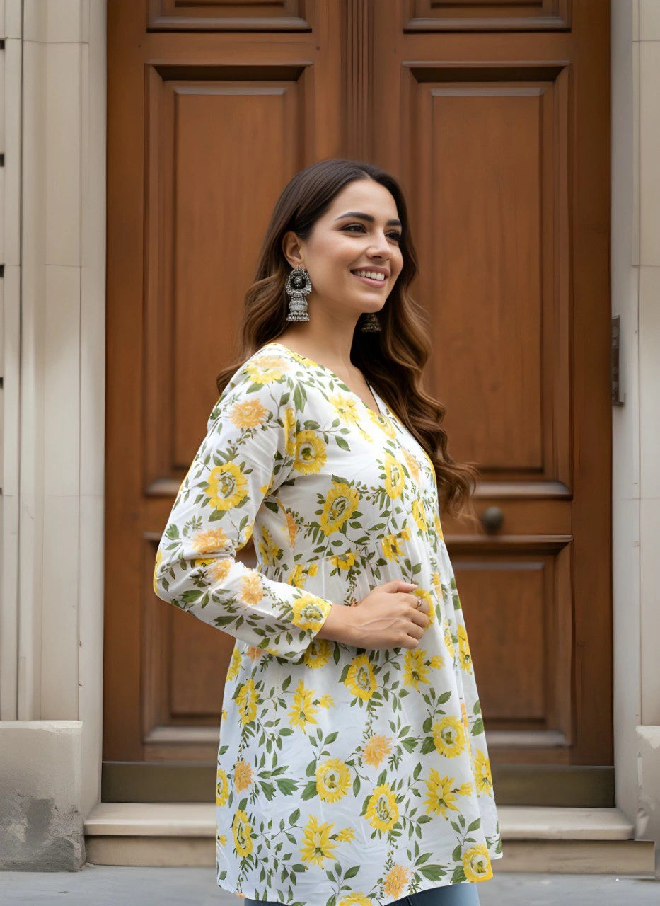 Woman wearing a floral dress standing in front of a wooden door.