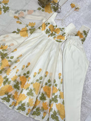 White dress with yellow floral pattern on a light gray background