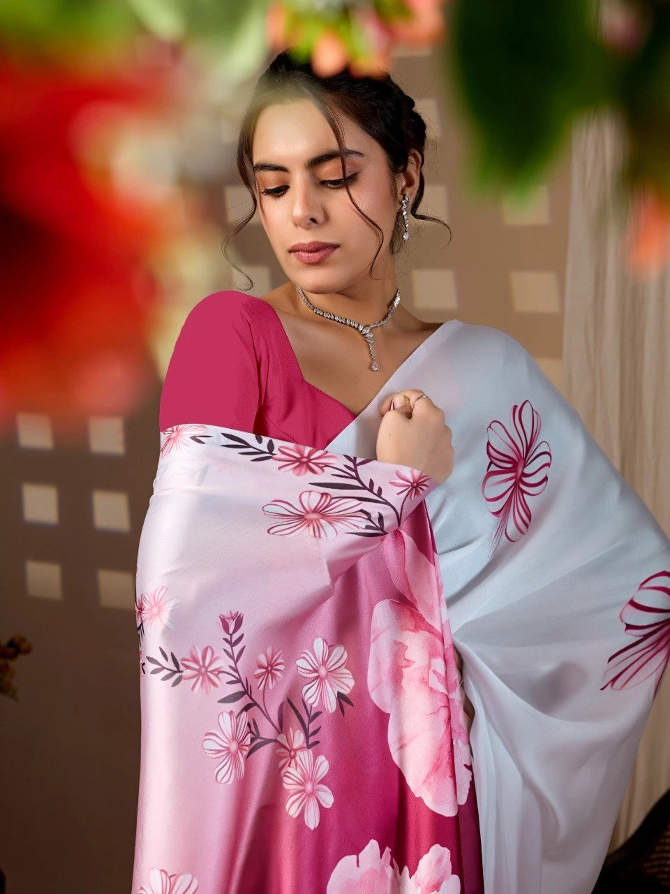 Woman holding a floral-patterned scarf with a blurred background