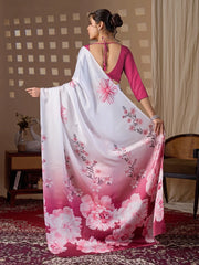 Woman wearing a floral saree with a pink blouse in a room setting.