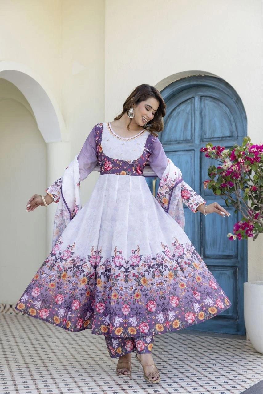 Stylish lavender Anarkali dress adorned with blooming floral prints, complemented by matching bottoms and a flowing dupatta.