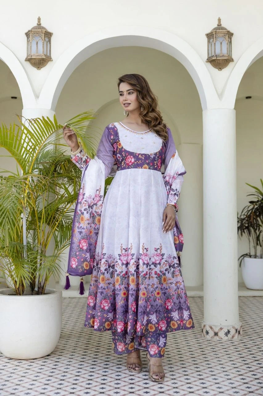 Traditional floral Anarkali suit showcasing soft pastel shades, intricate flower motifs, and a coordinated dupatta with tassel accents.