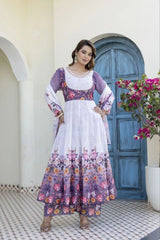 Woman wearing a lavender floral Anarkali suit with matching printed pants and a soft organza dupatta featuring elegant tassel details.
