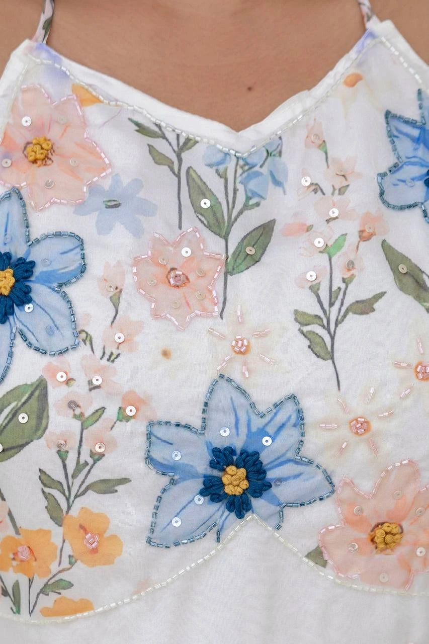 Close-up of a floral and butterfly patterned top with sequins.