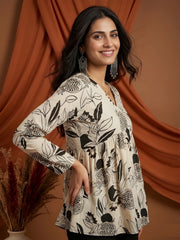 Woman wearing a floral patterned dress against an orange curtain background