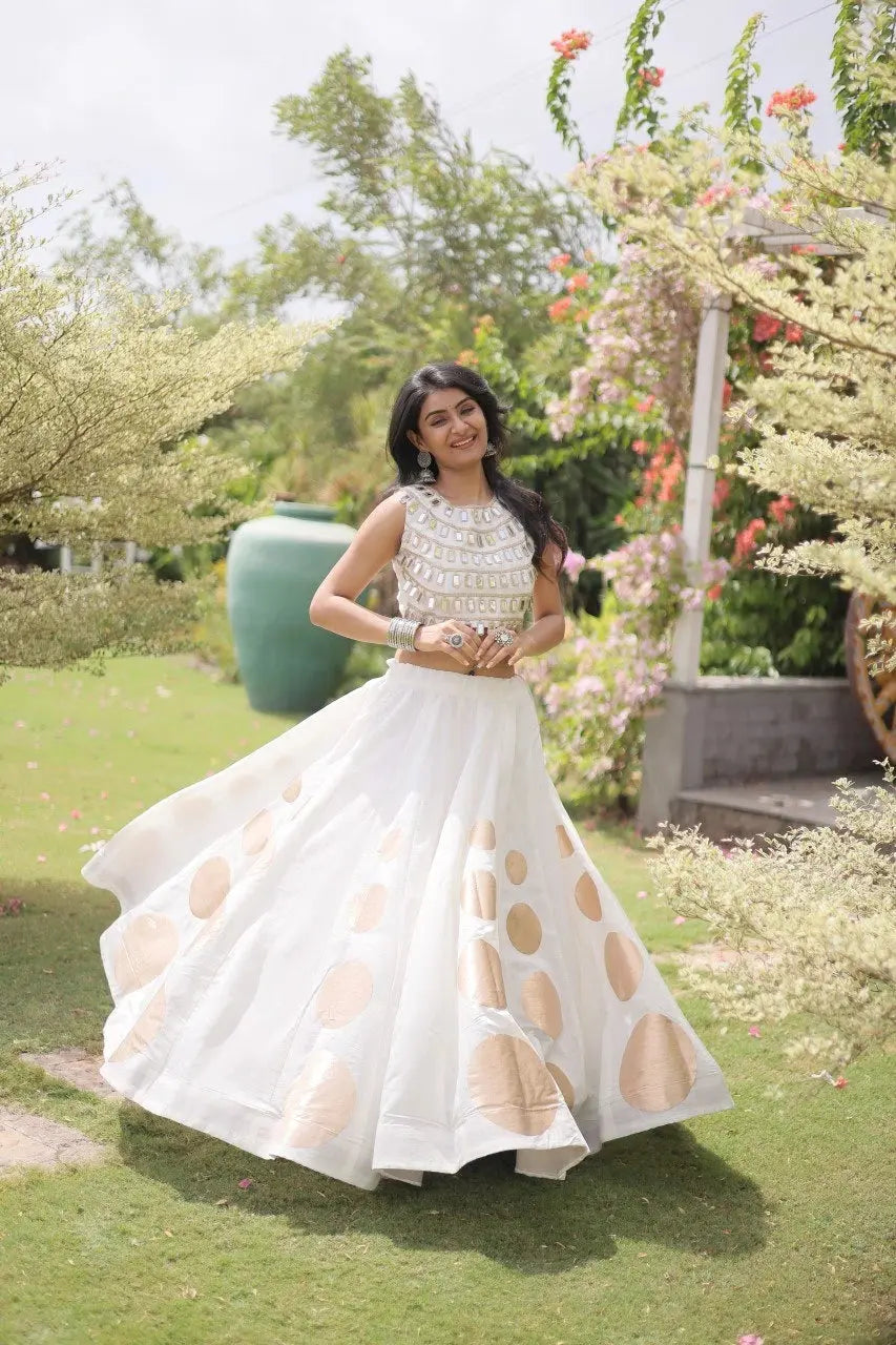 Eye-catching golden circular foil patterns add a sophisticated and festive touch to the elegant white skirt.