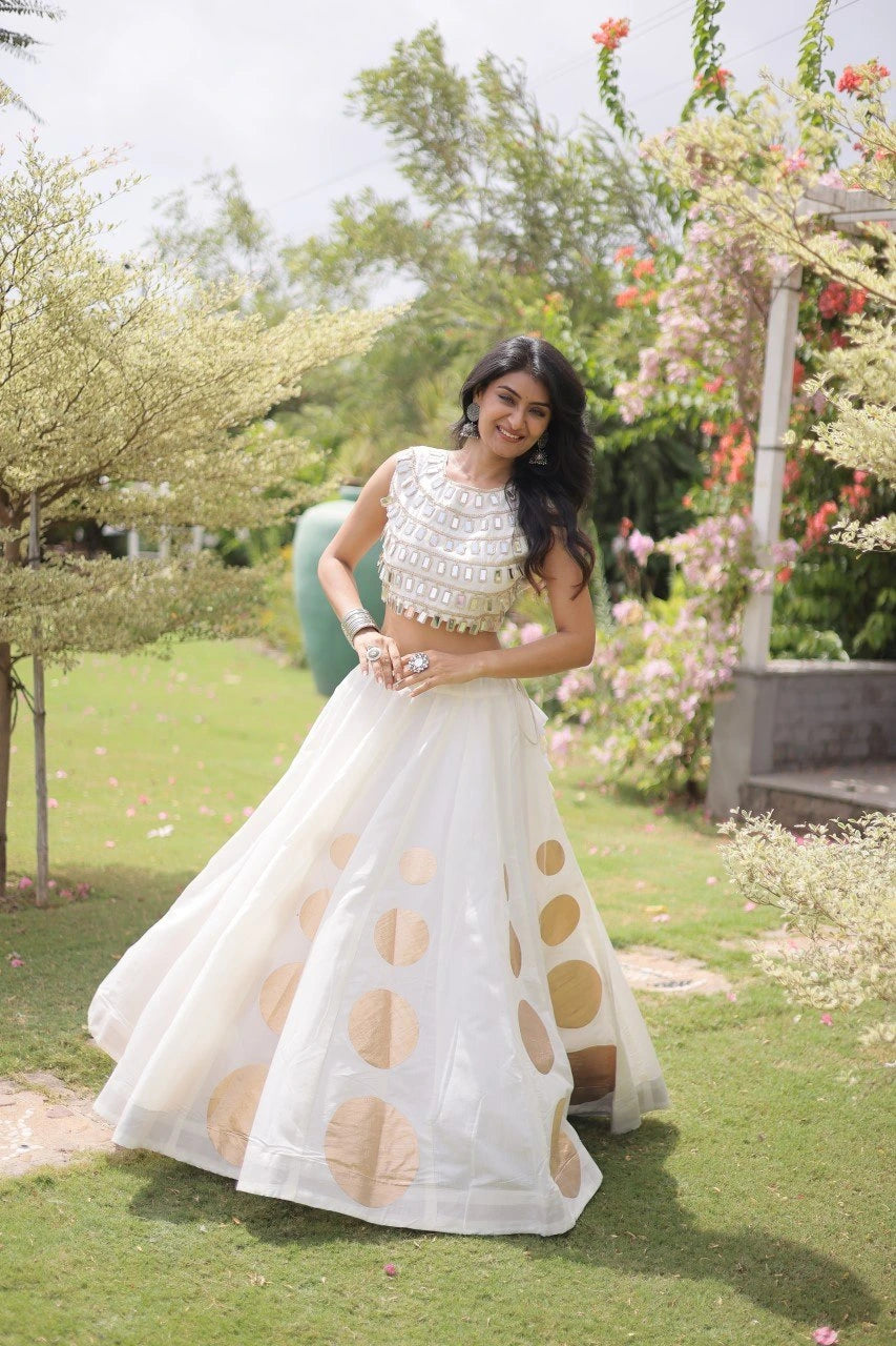 Stylish ethnic outfit combining a contemporary mirror work blouse with a flowing full-flare designer skirt.