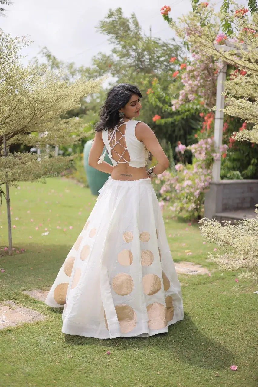 Premium white party wear lehenga designed with luxurious detailing and elegant traditional craftsmanship.