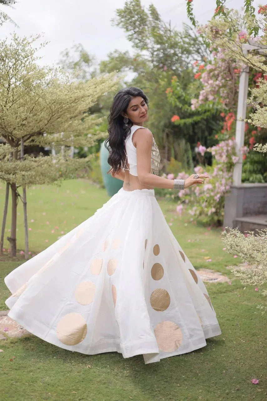 Sleeveless embellished blouse with intricate mirror work creates a stunning celebration-ready appearance.