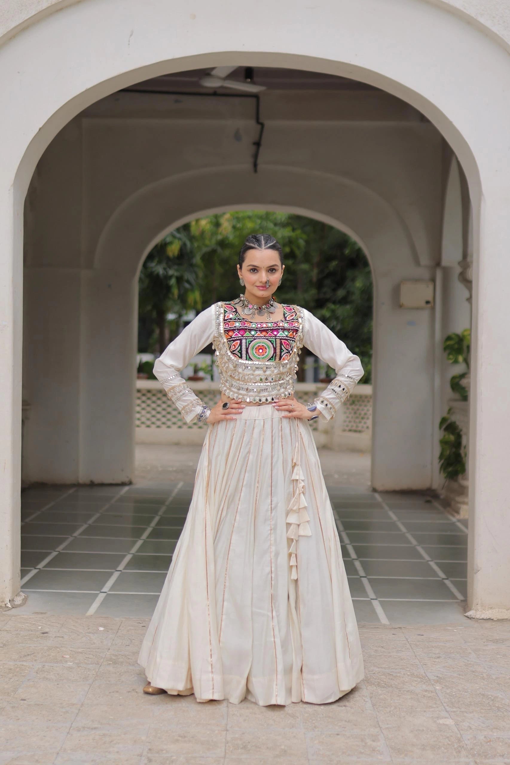 Woman in traditional outfit standing under an archway