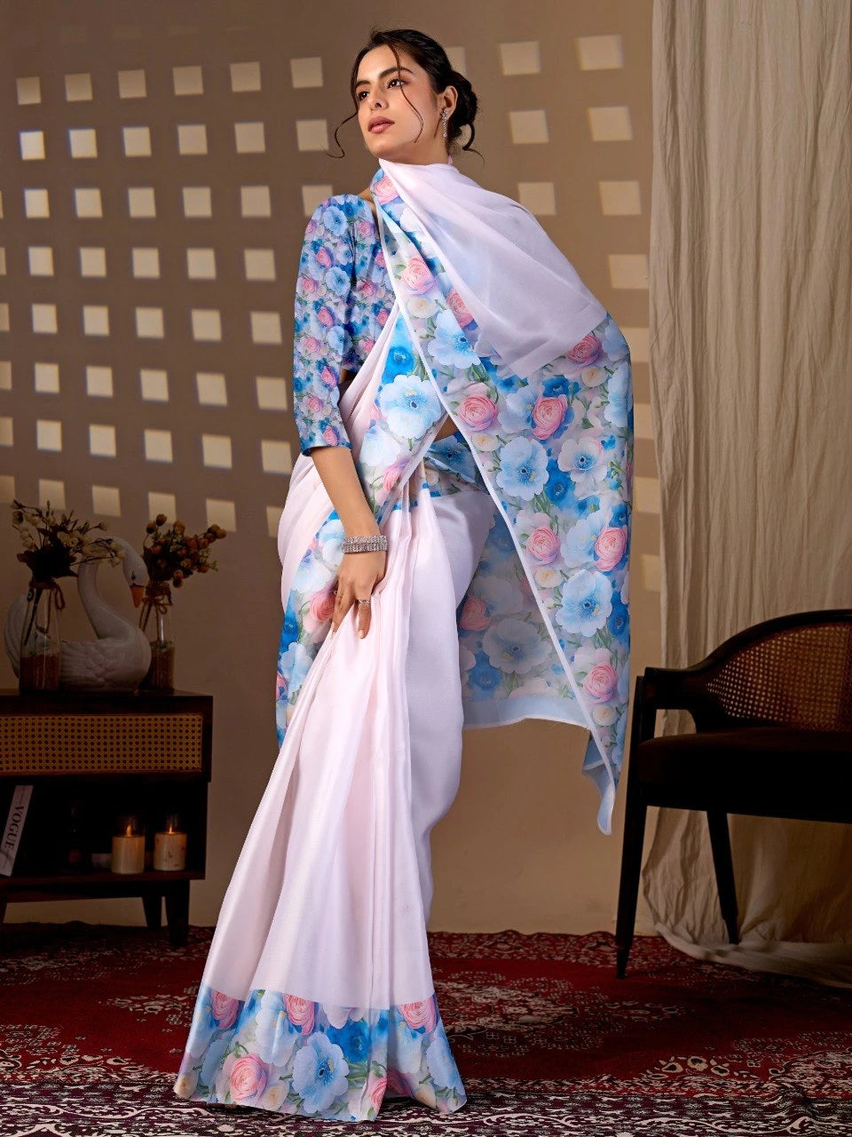 Woman wearing a floral saree with a checkered wall and decorative items in the background