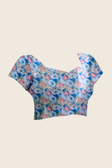 Floral patterned top on a beige background