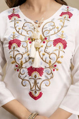 White blouse with intricate gold and red embroidery on a plain background