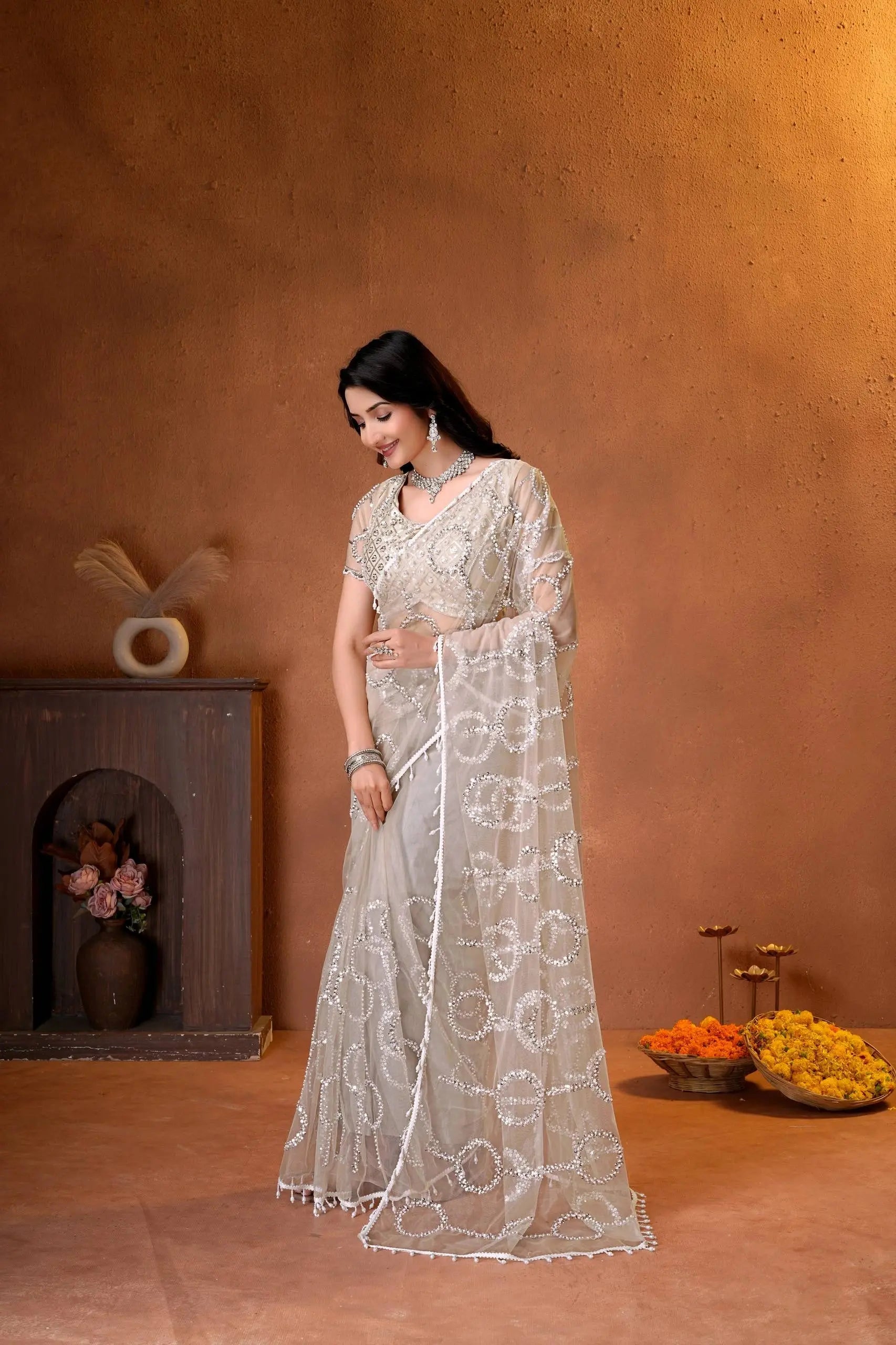 Premium party wear saree with a matching embroidered blouse, sheer embellished pallu, and luxurious ethnic styling.