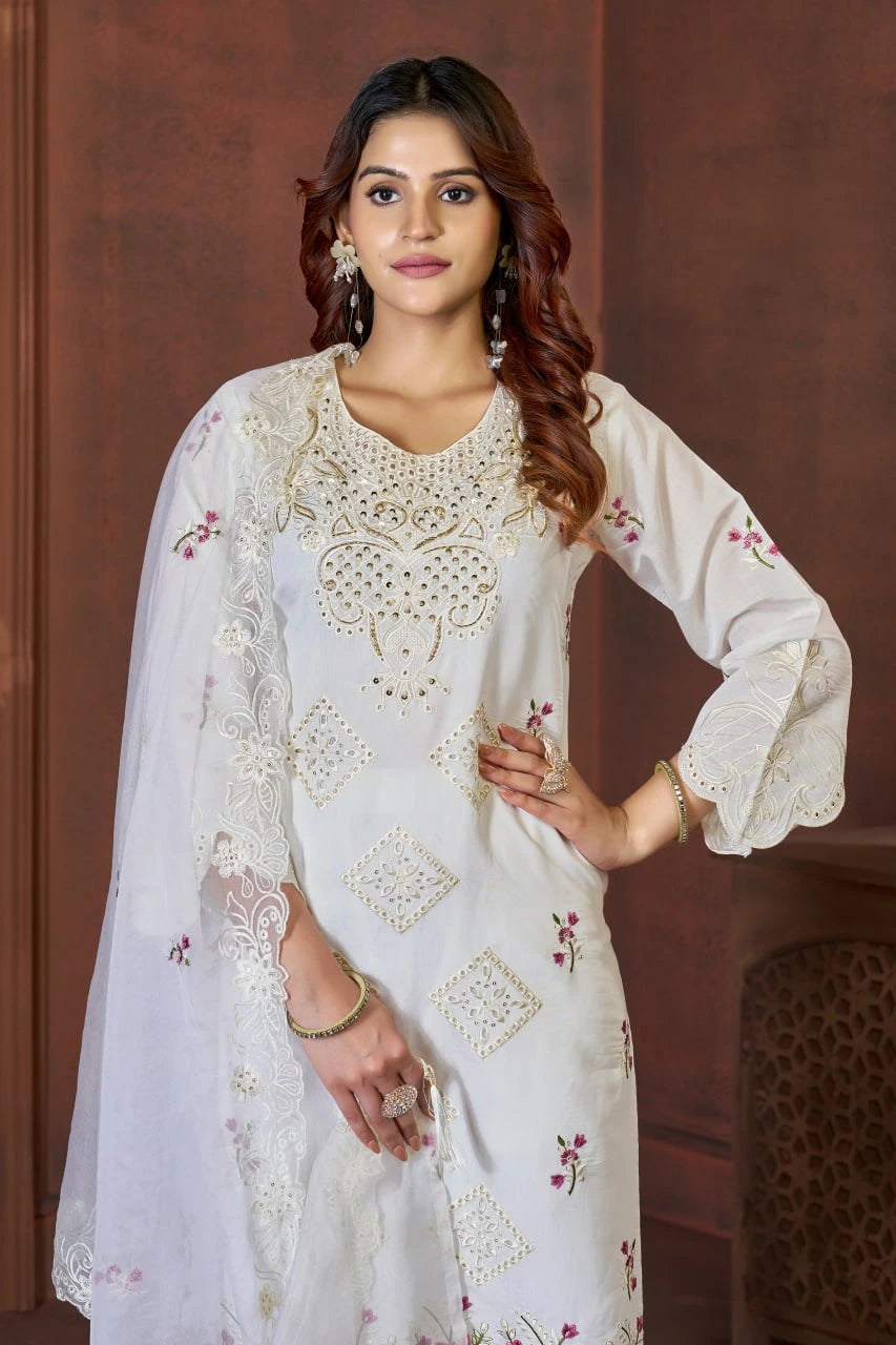 Woman wearing a white embroidered traditional outfit with a brown background