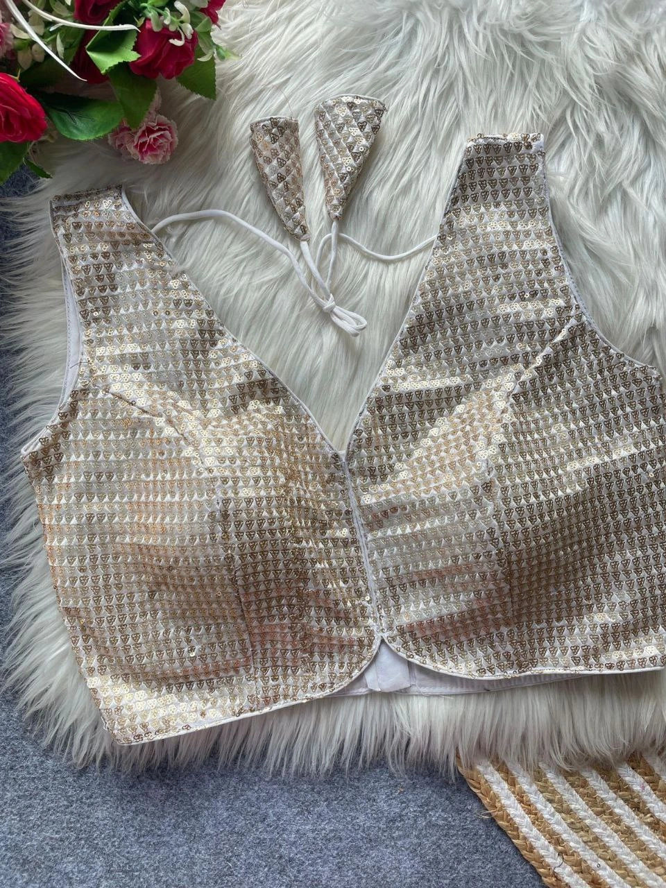 Gold sequin outfit with matching headband on a textured surface