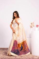 Woman wearing a traditional saree with a peacock design on a white background