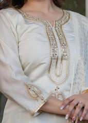 Luxurious white heavy Chanderi silk kurti folded neatly, showcasing embroidery and zari patterns.
