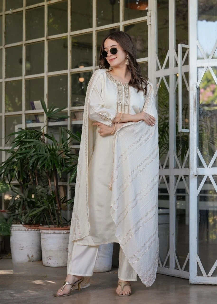 Close-up of white silk kurti highlighting fine thread embroidery and zari craftsmanship.