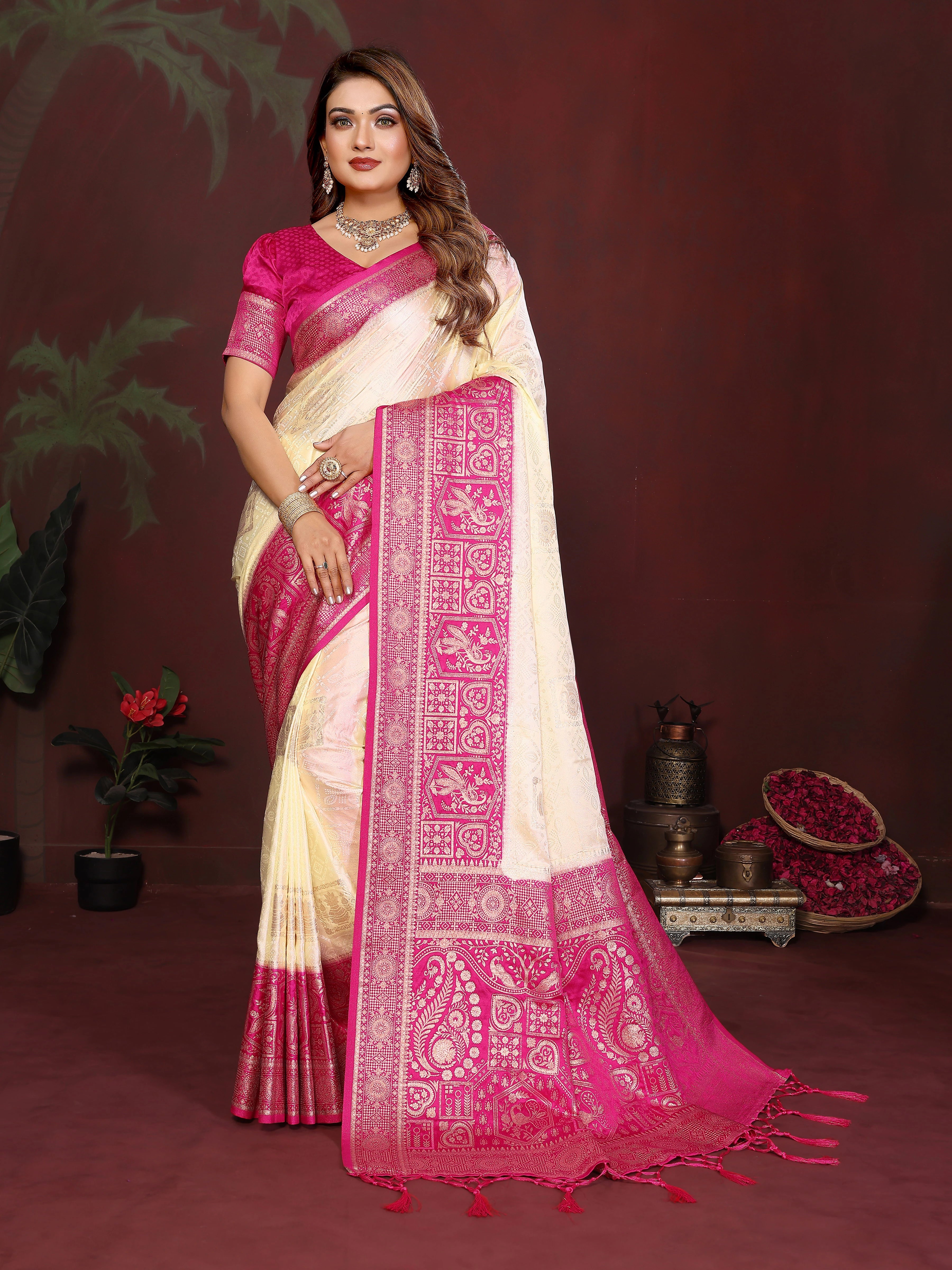 Woman wearing a pink and white saree with a dark background