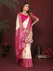 Woman in a pink and white saree with a floral bag on a dark red background